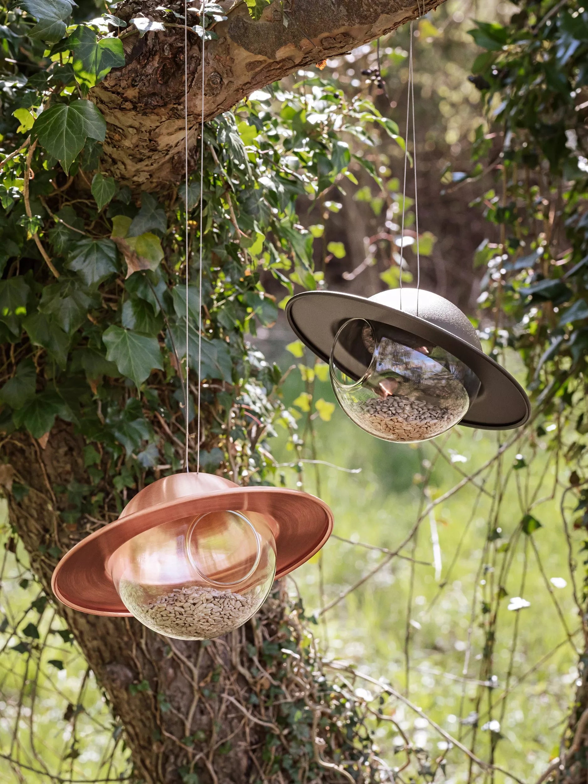 Eva Solo Saturn bird feeder with copper canopy and glass orb, imported from the UK