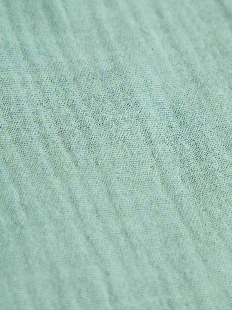 JoJo Maman Bébé green muslin frill bib, UK version