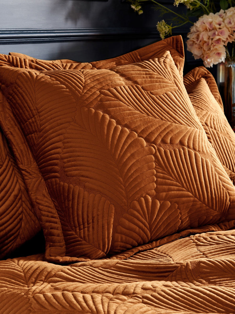 Paoletti orange Palmeria quilted velvet cushion 60cm, imported from the UK